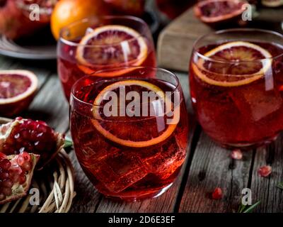 Blood orange and pomegranate cocktails on a grunge wooden table Stock Photo