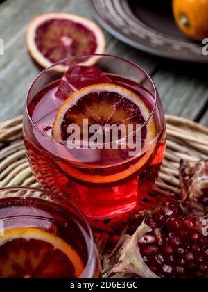 Blood orange and pomegranate cocktails on a grunge wooden table Stock Photo