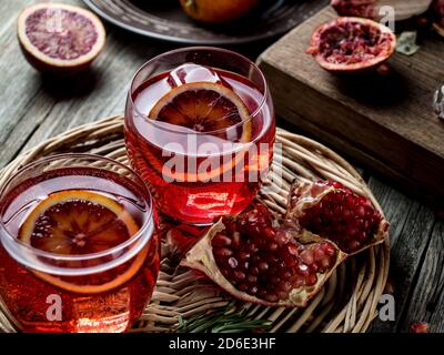 Blood orange and pomegranate cocktails on a grunge wooden table Stock Photo