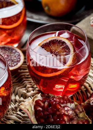 Blood orange and pomegranate cocktails on a grunge wooden table Stock Photo