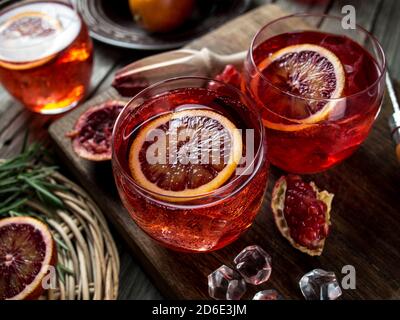 Blood orange and pomegranate cocktails on a grunge wooden table Stock Photo