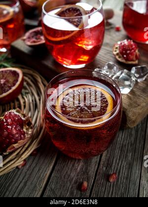 Blood orange and pomegranate cocktails on a grunge wooden table Stock Photo