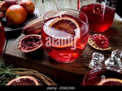 Blood orange and pomegranate cocktails on a grunge wooden table Stock Photo