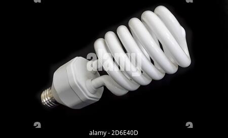 Lamp. Powersave lamp. White light bulb on black background Stock Photo