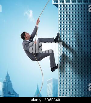 The businessman climbing skyscraper in challenge concept Stock Photo