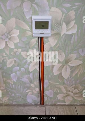 Closeup of concrete and red electrical wires. Electric floor heating system installation in new house. Closeup of concrete and red electrical wires Stock Photo