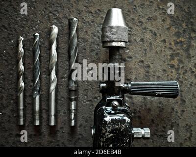 Old manual drill and drill bits Stock Photo