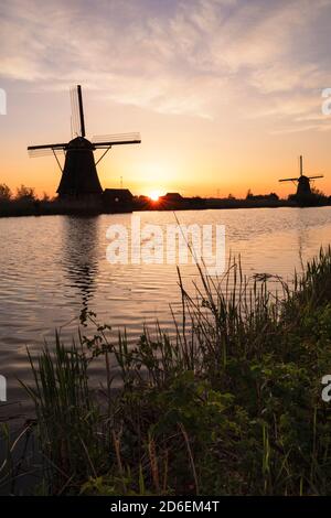 Windmill at sunrise, Kinderdijk, UNESCO World Heritage Site, South Holland, Netherlands Stock Photo