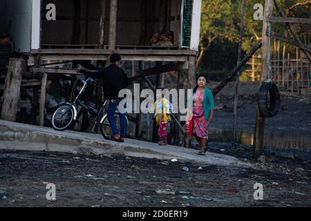 Chaung Thar, Myanmar - December 26, 2019: Young local people with traditional thanaka on their face by the shore on December 26, 2019 in Chaung Thar Stock Photo