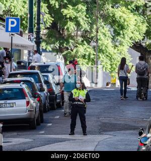 Traffic policeman in Lisbon, Portugal wearing a face mask Stock Photo