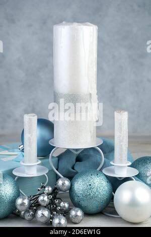 Christmas toys and candles, a composition with silver-blue tones. Stock Photo