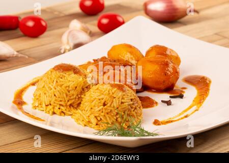 Rice, potatoes with chicken in curry sauce. Stock Photo