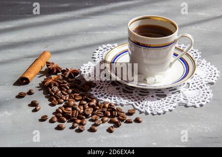A cup of coffee with coffee beans and cinnamon and anise Stock Photo