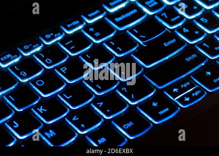 Illuminated blue computer keyboard - laptop, notebook Stock Photo