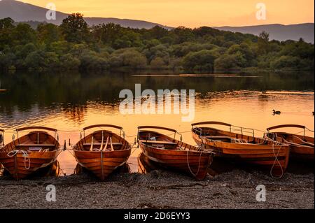 Wooden rowing boats on the shore of Derwentwater. Stock Photo