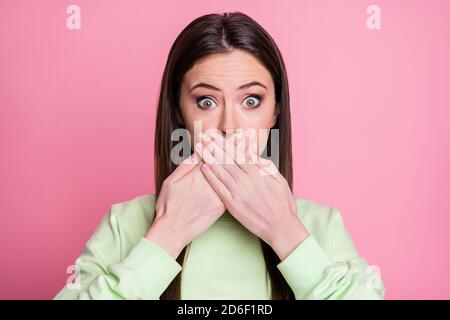 Closeup photo of pretty shocked lady straight long hairdo hiding mouth arms on lips say wrong phrase mistake wear casual green sweatshirt pullover Stock Photo