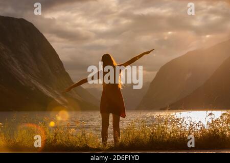 Silhouette of a woman doing yoga on the beach Stock Photo