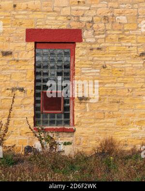 Glass block windows against stone wall of the Old Joliet State Prison in Joliet, Illinois Stock Photo