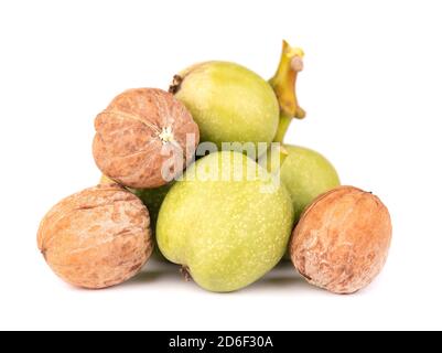 Green walnut, isolated on white background. Peeled walnut and kernels. Walnuts branch. Stock Photo