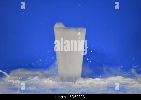 Shot of splashing milk from a cup Stock Photo