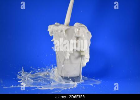 Shot of splashing milk from a cup Stock Photo