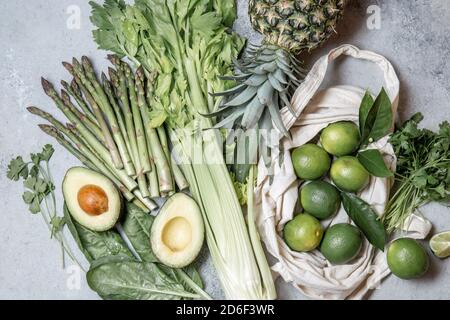 Healthy food ingredients gree vegetables and fruits on gray background. Stock Photo