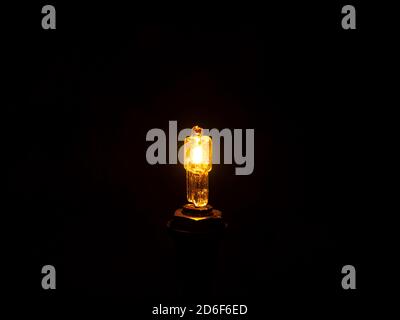 Glow of a halogen bulb in the dark. Stock Photo