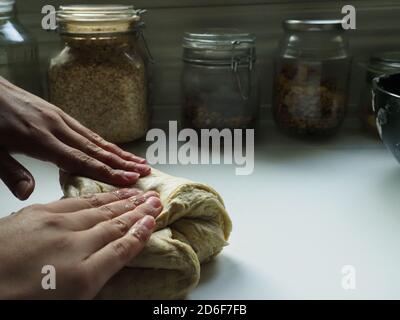 Hands of a woman with a bread dough Stock Photo