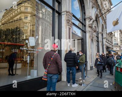 People queuing outside the Apple store in Covent Garden, London, as the ...