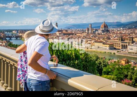two tourists (mother and daughter) are admiring the historic center of Florence, elevated view from the panoramic point of piazzale michelangelo, Florence, Tuscany, Italy, Europe Stock Photo