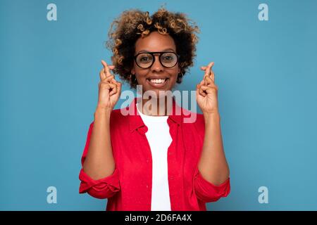 African young lady keeping her fingers crossed Stock Photo