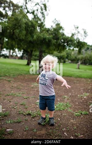Two Year Old Smiling for Camera Standing in Park