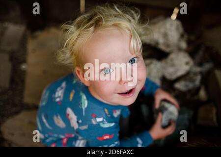 Two Year Old Holding Rock Smiling for Camera Stock Photo