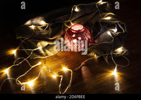 small white lights on and a Chinese candle holder on a wooden table Stock Photo