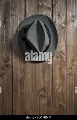 an old hat hanging on a wooden wall Stock Photo
