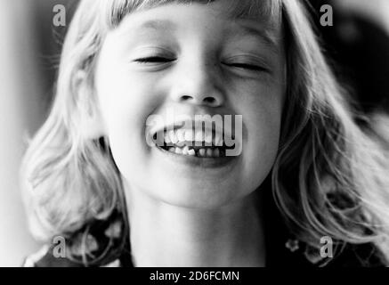 portrait of a young girl showing her wobbly tooth smiling Stock Photo