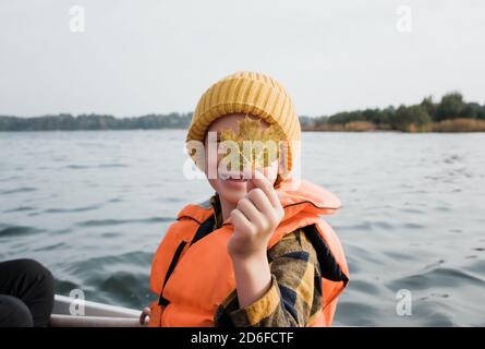 Little boy holding up fish he caught in a pond Stock Photo - Alamy