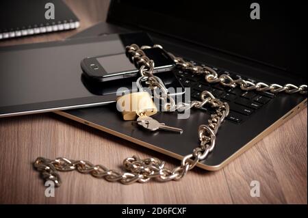 laptop with chain and unlocked padlock, computer and data security concept. Stock Photo