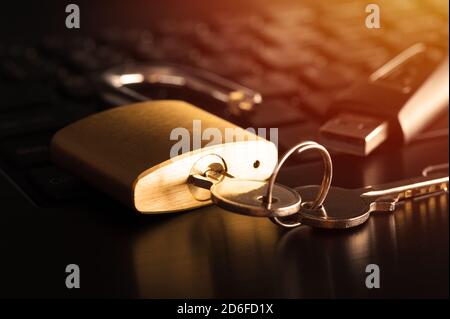 unlocked padlock on the laptop's keyboard, computer and data security concept. Stock Photo