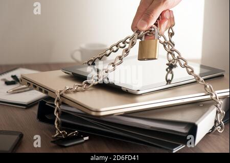 important information locked with chain and padlock, computer and data security concept. Stock Photo