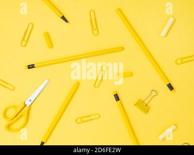 Back to school, education concept. School tools, stationery accessories isolated on yellow color studio background with copyspace. Flat lay, view from Stock Photo