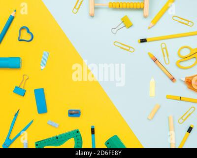 Back to school, education concept. Blue stationery tools and yellow school tools isolated on dual color yellow and blue studio background with copy sp Stock Photo