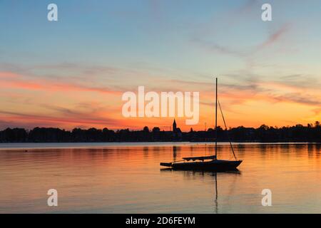 Sailboat at sunset on the Chiemsee, Riemsting, Upper Bavaria, Germany Stock Photo