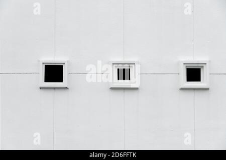 three window frames on white cement concrete wall minimalism architecture white background Stock Photo