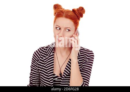 Skeptical by phone. Closeup portrait cut out of a beautiful woman in her 30s being doubtful while talking at smartphone wearing striped black white ja Stock Photo