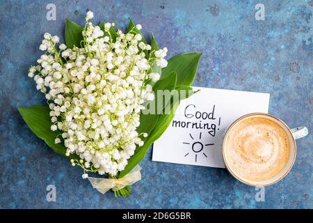 Notes good morning and bouquet of flowers lily of the valley on blue ...