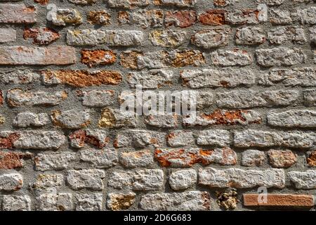 Background from a weather-beaten old red brick wall Stock Photo