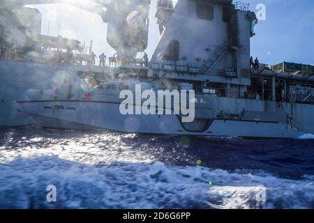 (PHILIPPINE SEA Oct. 4, 2020) Patrol Boat (PB) Mk VI 1206 assigned to Maritime Expeditionary Security Squadron 3 conducts refueling at sea with amphibious dock landing ship USS Comstock (LSD 45) in preparation of PB Mk VI integration. Maritime Expeditionary Security Force and Explosive Ordnance Disposal Mobile Unit Sailors assigned to Commander, Task Force 75 (CTF 75) embarked and are conducting integrated littoral maritime security operations from the amphibious dock landing ship USS Comstock (LSD 45) with the Marines and Sailors already deployed as Task Force Ellis from I Marine Expeditionar Stock Photo