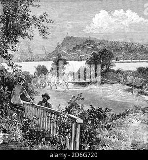 A 19th Century couple enjoy the view from the Old Manor at Beauport across the St Lawrence River to  of Quebec, one of the thirteen provinces and territories of Canada.. Stock Photo