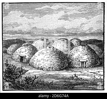 A clochán, or beehive huts, dry-stone buildings with a corbelled roof, commonly associated with the south-western Irish seaboard. The precise construction date of most of these structures is unknown with the buildings belonging to a long-established Celtic tradition, though there is at present no direct evidence to date the surviving examples before the first century AD. Many occur in religious contexts such as used by the monks following Saint Patrick. Stock Photo